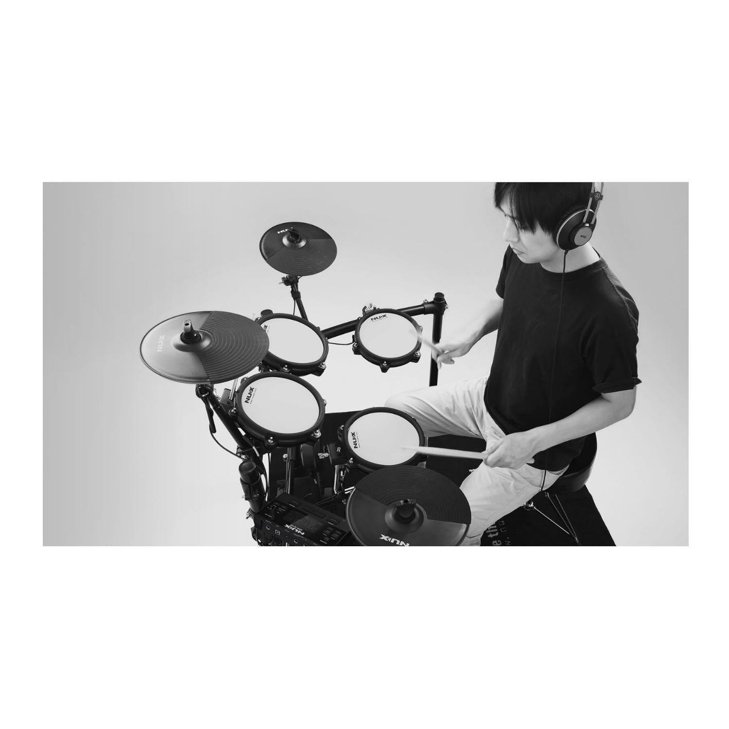 Drummer playing the NUX DM-210 all-mesh electronic drum kit